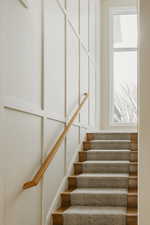 Staircase featuring a wealth of natural light