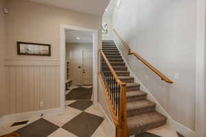 Stairway featuring marble finish floor, baseboards, visible vents, and recessed lighting