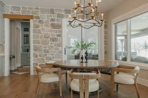 Dining space featuring a notable chandelier and wood finished floors