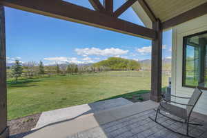 View off of master bedroom patio / terrace featuring a mountain view, a rural view, and a fenced backyard