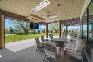 View of patio / terrace with an outdoor living space, fence, outdoor dining area, and a ceiling fan