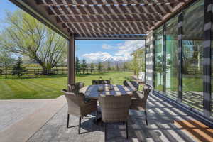 View of patio / terrace with a pergola, fence, and outdoor dining space