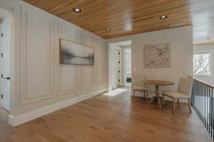 Sitting room featuring light wood-style floors, recessed lighting, wooden ceiling, and visible vents