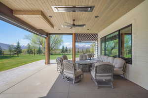 View of patio featuring an outdoor hangout area, visible vents, ceiling fan, and fence