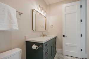 Bathroom featuring vanity and toilet