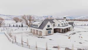 Snowy aerial view featuring a mountain view