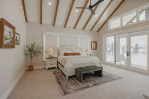 Bedroom featuring access to exterior, light colored carpet, beamed ceiling, and high vaulted ceiling