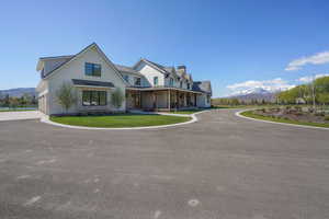 Modern inspired farmhouse featuring a mountain view, a chimney, metal roof, and a standing seam roof