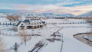 Snowy aerial view featuring a mountain view