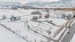 Snowy aerial view featuring a mountain view