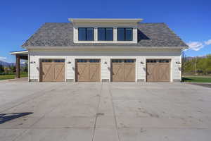 Garage featuring concrete driveway and a mountain view