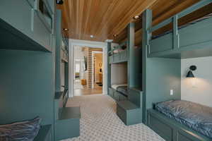 Mudroom featuring recessed lighting, wooden ceiling, and light carpet