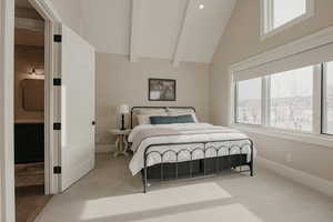 Carpeted bedroom with baseboards, multiple windows, high vaulted ceiling, and beam ceiling