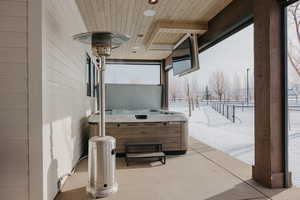 View of patio / terrace featuring fence and a hot tub