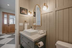 Half bathroom with toilet and vanity