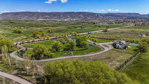 Birds eye view of property with a mountain view and a rural view