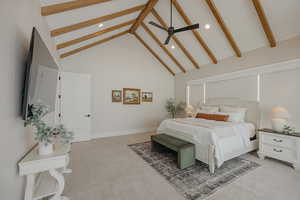 Bedroom with beam ceiling, light colored carpet, a ceiling fan, high vaulted ceiling, and baseboards