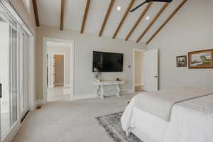 Bedroom with beam ceiling, light colored carpet, visible vents, high vaulted ceiling, and baseboards