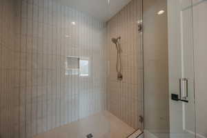 Full bath featuring a shower stall