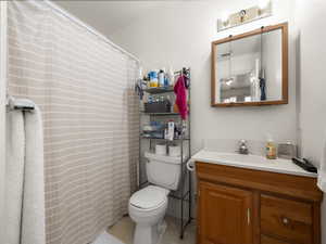 Full bathroom featuring toilet and vanity