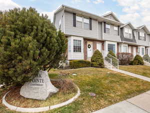 Multi unit property with a front yard and brick siding