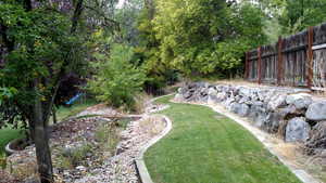 View of yard featuring fence