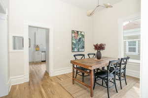 Dining area featuring light wood-style flooring and baseboards