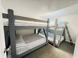 Bedroom featuring baseboards and a textured ceiling