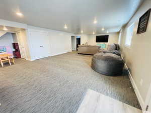 Living room with recessed lighting, light colored carpet, visible vents, and baseboards