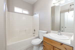 Full bath featuring toilet, vanity, shower / washtub combination, and tile patterned floors