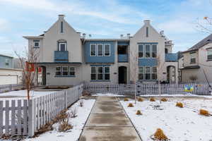 View of front of house with a fenced front yard and stucco siding