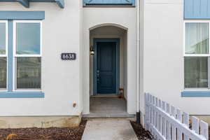 Entrance to property with stucco siding