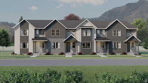 View of front of home featuring a front yard and a mountain view