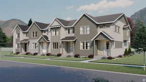 View of front of property featuring stone siding, a front lawn, board and batten siding, and a mountain view