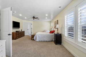 Bedroom with a textured ceiling, recessed lighting, baseboards, and light colored carpet