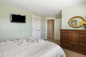 Bedroom featuring baseboards and light colored carpet