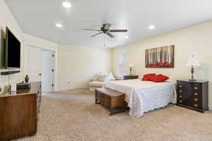 Bedroom featuring recessed lighting, light carpet, ceiling fan, and baseboards