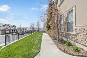 View of yard featuring a residential view and fence