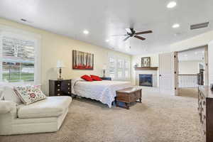 Carpeted bedroom featuring a textured ceiling, visible vents, and recessed lighting