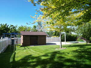 View of yard with an outbuilding and a playground