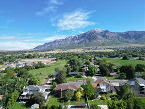 Aerial overview of property's location featuring mountains and nearby suburban area