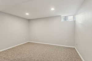 Below grade area with baseboards, carpet, and recessed lighting