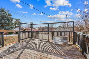 Wooden terrace featuring fence