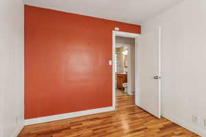 Unfurnished room with light wood-style floors and baseboards