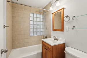 Full bath with shower / bath combination, vanity, and toilet