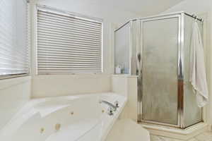 Bathroom with a jetted tub and a stall shower