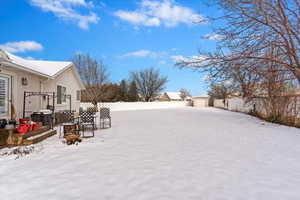 Yard layered in snow with fence