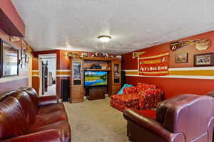 Carpeted living area with a textured ceiling