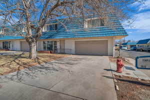 View of front of home with driveway, an attached garage, and brick siding