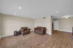 Living area featuring baseboards, visible vents, and light wood-style floors